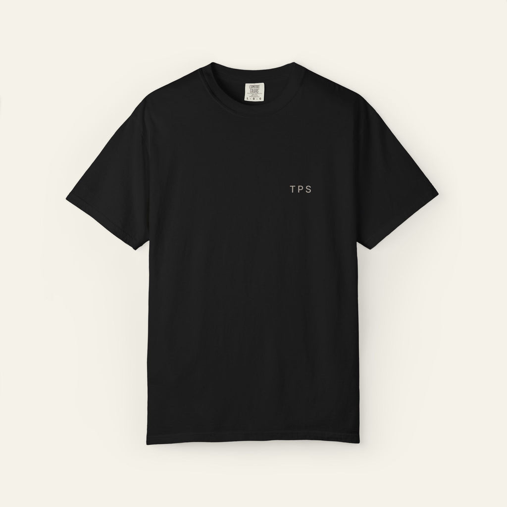 Black t-shirt with 'TPS' text mark on a neutral background